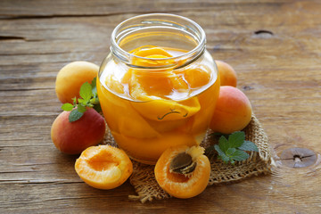 canned peaches fruit in a glass jar © Olga Kriger