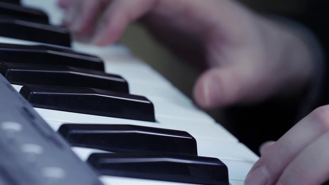 HD 1080 stock footage steadicam: keyboard player playing synthesizer; close up; 