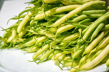 Black eyed pea pods on white plate