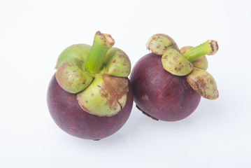 Mangosteen fruit and cross section showing the thick purple skin