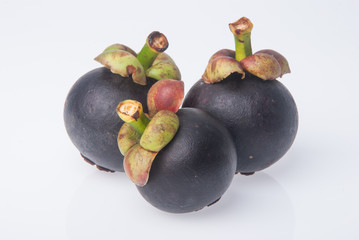 Mangosteen fruit and cross section showing the thick purple skin