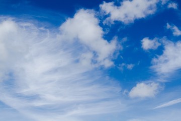 Wispy and fluffy clouds on blue sky