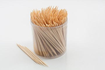 Wooden toothpicks  for hygiene of cavities mouth in transparent plastic box isolated on white...