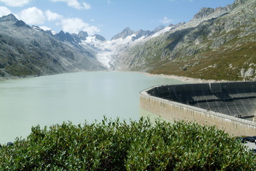 View of the Grimsel lake dam and the Oberaare glacier - obrazy, fototapety, plakaty
