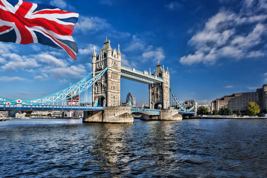 Famous Tower Bridge with flag of England in London, UK