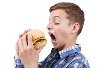 Hungry teenager wants to eat a big hamburger