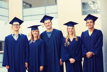 group of smiling students in mortarboards