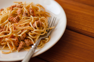 Spaghetti with sauce on a white plate