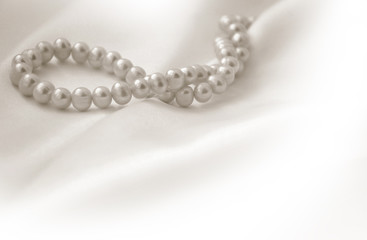 Elegant beige background with lace, silk and pearls