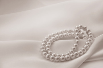 Elegant beige background with lace, silk and pearls