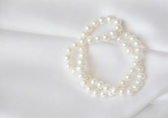 Elegant white background with lace, silk and pearl