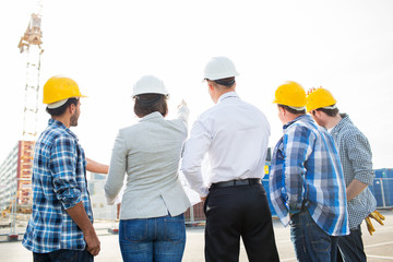 group of builders and architects at building site