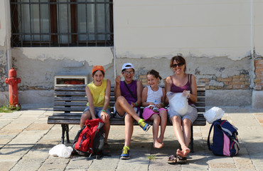 happy family laughing and eating on the bench