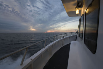Sunset view on the ocean from a boat