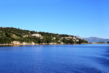 Fototapeta na wymiar Sea view. Mountain view. Town view. Beautiful Ionian dark blue sea. Sky and sea. Beauty in nature. Corfu. Kerkyra. Greece island