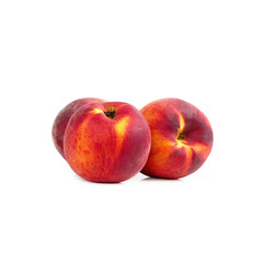 Three peaches on white table