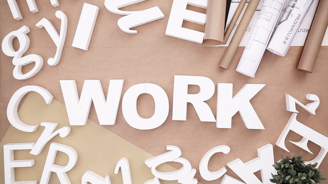 Work - people building word from letters
