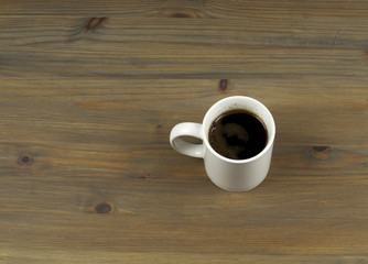 Coffee cup on wooden table background