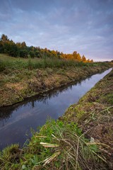 Sunrise over meadow and river