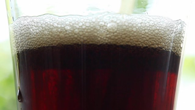 HD 1080 static: cold cola drink poured into high cold glass; close up