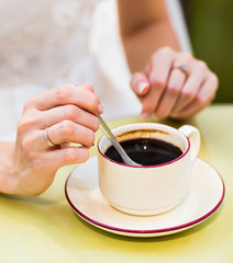  female hands hold a cup of coffee 