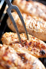 Grilled chicken breast on barbeque