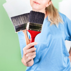 Young woman with paint brushes