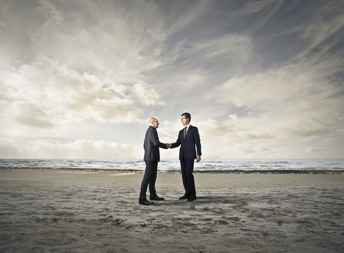 Businessmen meeting at the beach