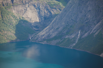 Beautiful norwegian vibrant summer landscape with fjord, mountain and lake, lake Ringedalsvatnet on the way to famous Trolltunga, Skjegeddal rock, near Odda, Hordaland, Norway.
