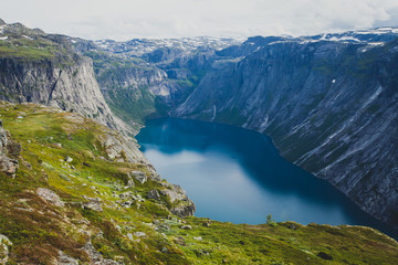 Naklejka premium Beautiful norwegian vibrant summer landscape with fjord, mountain and lake, lake Ringedalsvatnet on the way to famous Trolltunga, Skjegeddal rock, near Odda, Hordaland, Norway. 