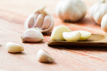 Organic garlic whole and cloves on the wooden background
