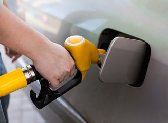 Driver pumping gasoline at the gas station