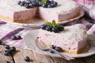 Cutting slice of delicious blueberry cheesecake close-up. horizontal
