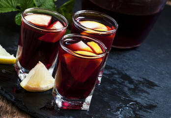 Red wine with lemon and orange, selective focus