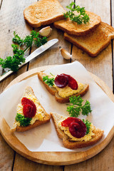 Bruschetta with cheese, garlic and jerked sausage on paper
