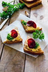 Bruschetta with cheese, garlic and jerked sausage on paper