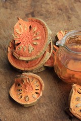 Slices of dried bael fruit and juice