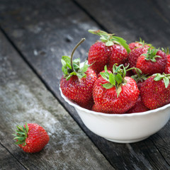Ripe red strawberries on wooden table