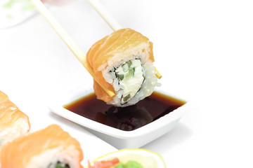 Sushi roll Philadelphia in chopsticks