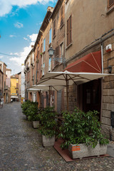 Fototapeta na wymiar Ancient medieval street in the downtown of Ferrara city