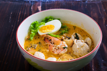 Asian noodle with seafood and egg in the tomyum soup