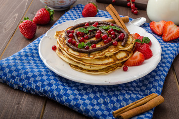 Cinnamon pancakes with chocolate sauce and berries