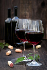 Glass of red wine on old wooden table