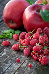 Concept of red berries and fruits on wooden board