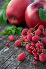 Concept of red berries and fruits on wooden board