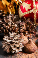 Chocolate truffles, sprinkled with cocoa powder, red Christmas b