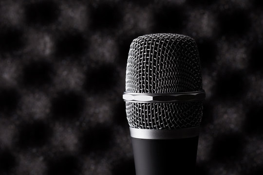 Wireless microphone closeup on foam acoustic background