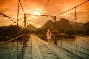 Female tourists walking on a wooden bridge