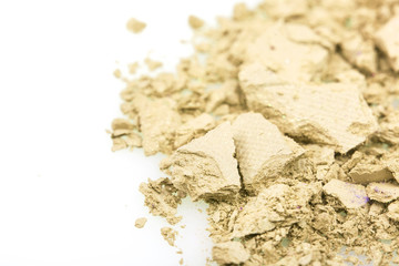 Crushed yellow eyeshadows on white background