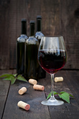 Glass of red wine on old wooden table